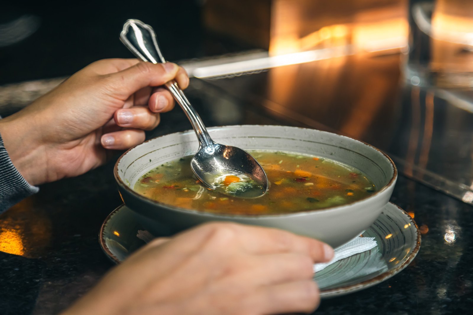 woman-cafe-eats-lowcalorie-vegetable-soup-scaled.jpg